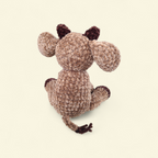Crocheted cow on a beige background