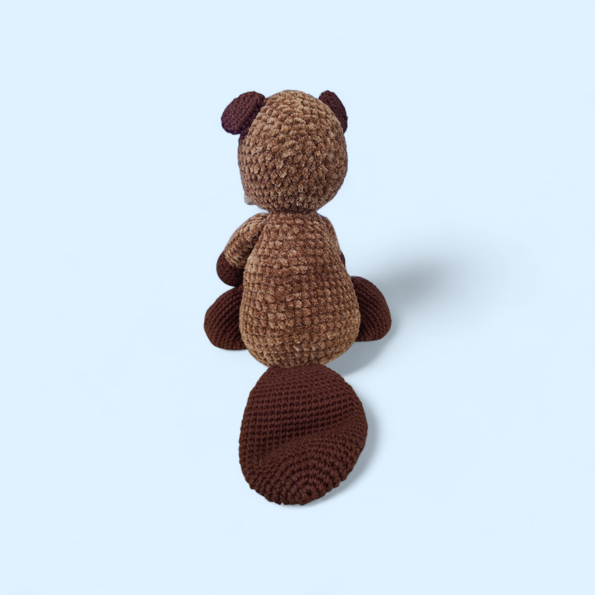 Brown crocheted Beaver on a blue background