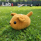Crocheted brown dog with black eyes on a white background