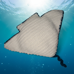 Crocheted Manta Ray with a white belly and sparkly blue tail on a light blue background