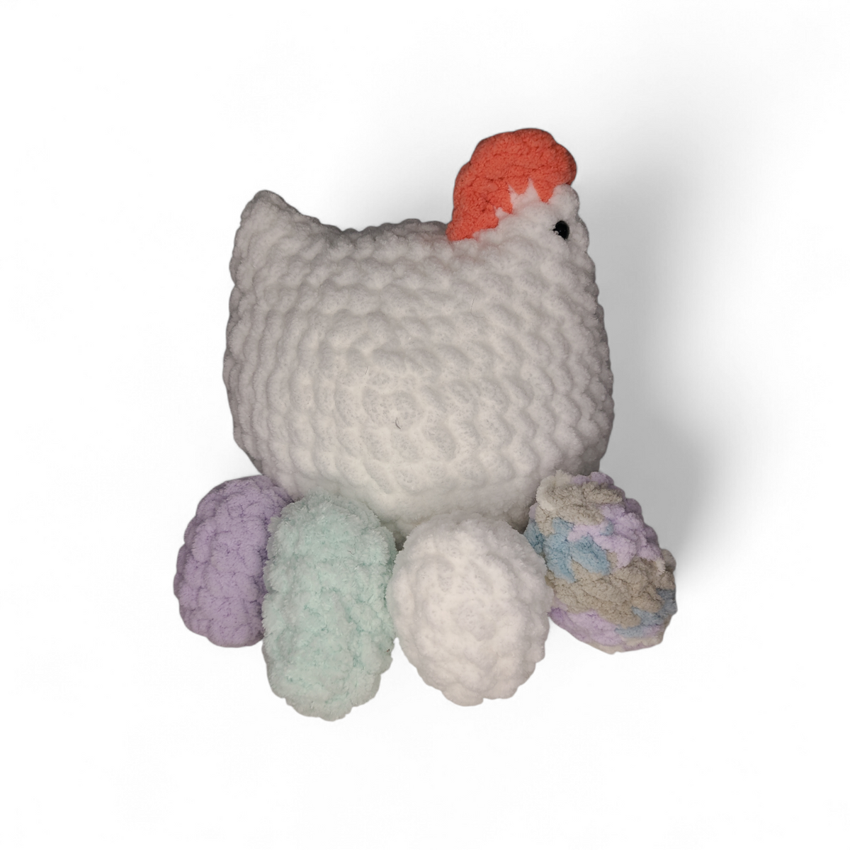Crocheted white chicken with 4 eggs in purple, mint, white and variegated colors on a white background