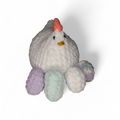 White crocheted chicken with 4 eggs in lavender, white, mint and rainbow on a white background