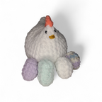 White crocheted chicken with 4 eggs in lavender, white, mint and rainbow on a white background