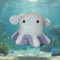 Light blue crocheted dumbo octopus with purple tentacles on a light blue background